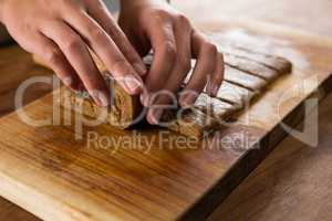 Woman arranging dough on chopping board