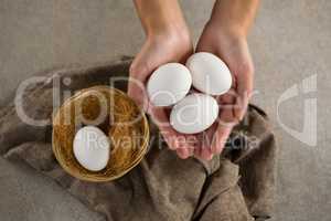 Woman holding white eggs