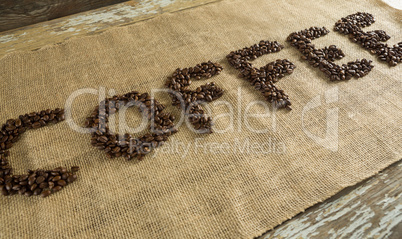 Word coffee arranged with coffee beans