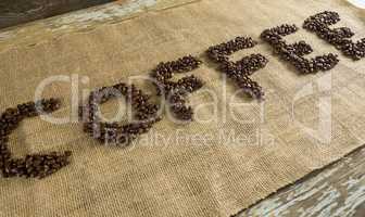 Word coffee arranged with coffee beans