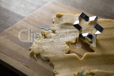 Raw cookie dough with star shape and cutter