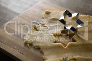 Raw cookie dough with star shape and cutter