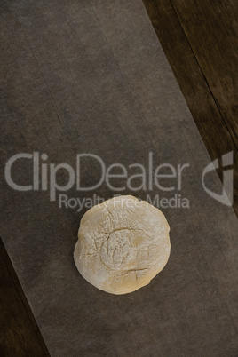 Dough ball pressed on butter paper