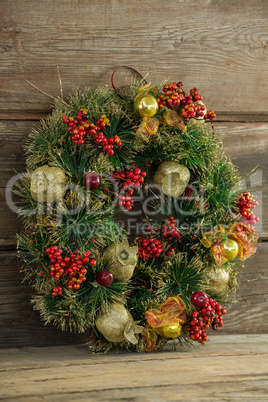 Christmas wreath against wooden background