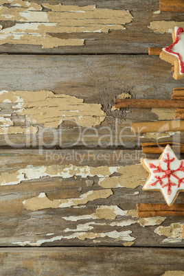 Christmas cookies and cinnamon wooden plank