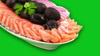 Salmon sliced in thin slices and black olives.