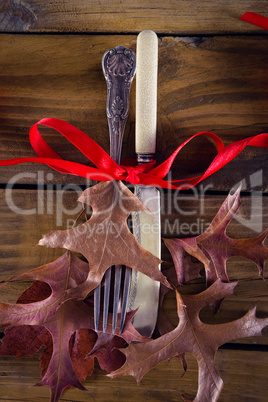 Tied knife and fork on wooden table