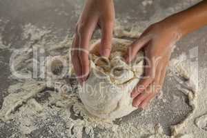 Woman kneading a dough