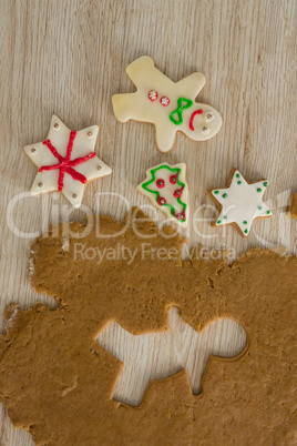 Gingerbread dough with star shapes on wooden table