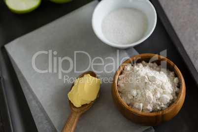 Bowl of sugar and flour with butter in spoon