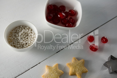 Red cherries in bowl with star shape cookies and cutter