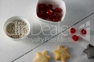 Red cherries in bowl with star shape cookies and cutter