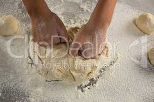 Woman kneading a dough