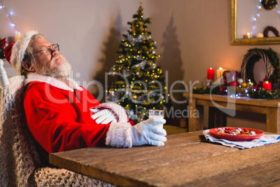 Santa Claus sleeping on chair