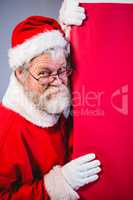 Santa Claus peeking from red board