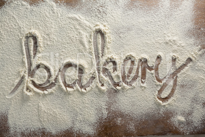 The word bakery written on sprinkled flour