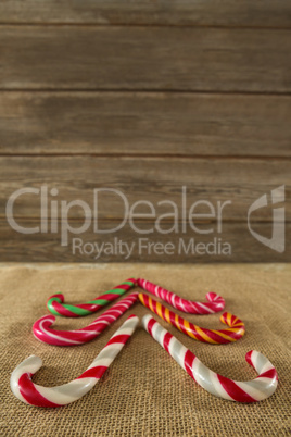 Multicolored candy canes arranged on fabric