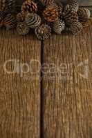 Pine cones on wooden plank