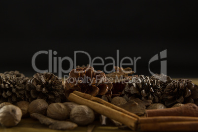 Close up of walnuts with pine cones and cinnamon stick
