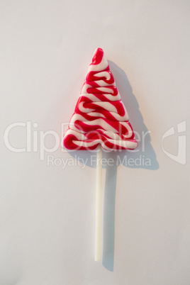 Christmas tree lollipop on white background