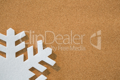 White snowflake on brown background