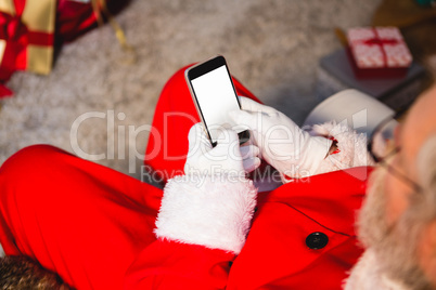 Santa claus using mobile phone at home