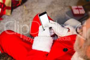 Santa claus using mobile phone at home