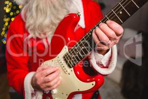 Mid-section of santa claus playing a guitar
