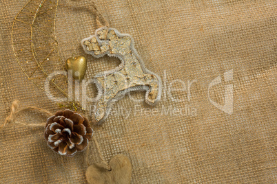 Overhead view of reindeer and pine cone decoration