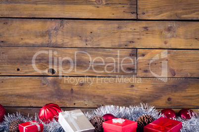 Gift boxes and christmas decorations against wooden background