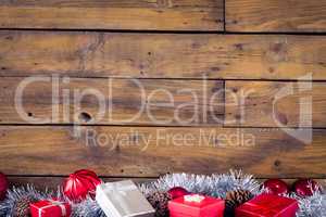 Gift boxes and christmas decorations against wooden background