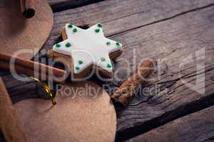 Cinnamon sticks, cookies and christmas decoration on wooden plank