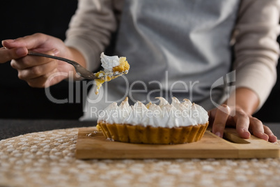 Woman picking up tart with a fork