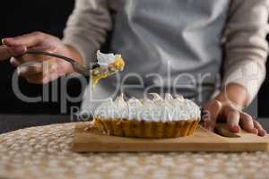Woman picking up tart with a fork