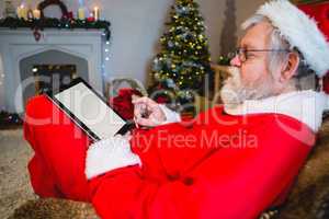 Santa Claus using digital tablet