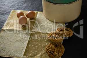 Brown eggs and cookies on a decoration paper