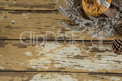 Cookies with christmas decoration arranged on wooden plank