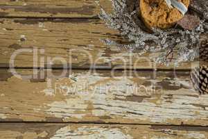 Cookies with christmas decoration arranged on wooden plank