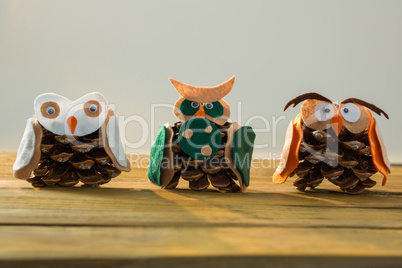Close up of owls made with pine cones