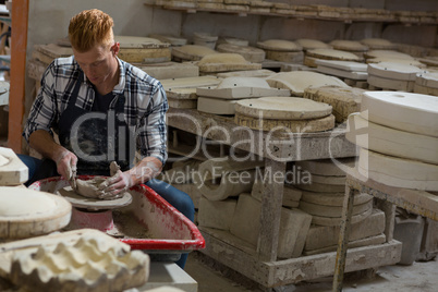 Male potter making a pot