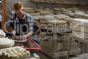 Male potter making a pot