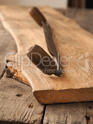 Old wood plane on oak plank