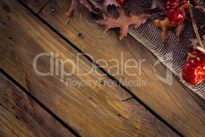 Dry leaves and mistletoe on wooden plank