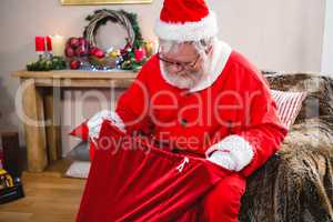 Santa claus looking in his gift sack