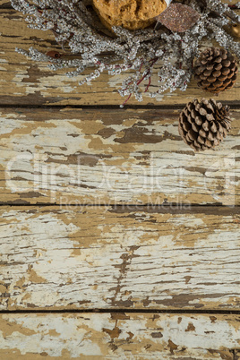 Cookies with christmas decoration arranged on wooden plank