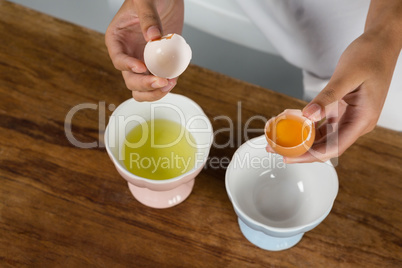 Woman holding a broken egg