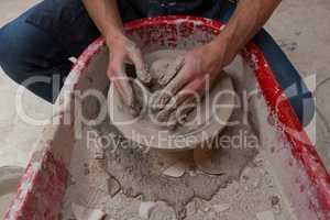 Male potters hand making a pot