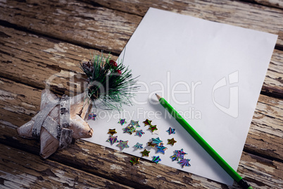 Christmas decoration, pen and blank paper on wooden plank