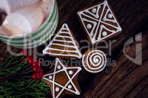 Cookies, mistletoe and hot chocolate on wooden plank