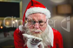 Santa Claus blowing kiss